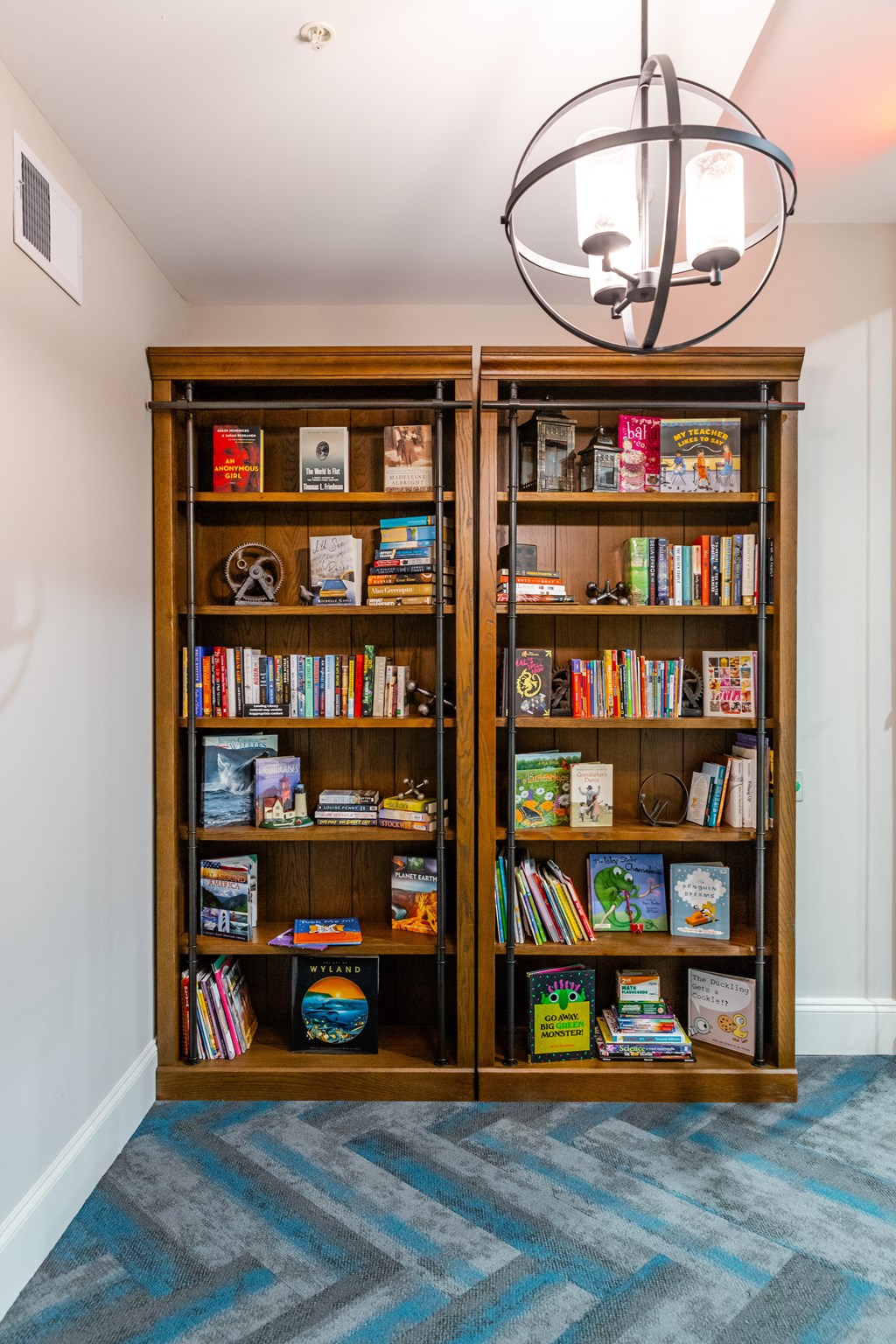 a bookcase filled with childrens books in a living room