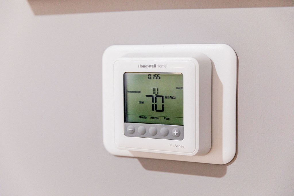 a thermostat with a white background and a green screen