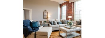 a living room filled with furniture and a large window