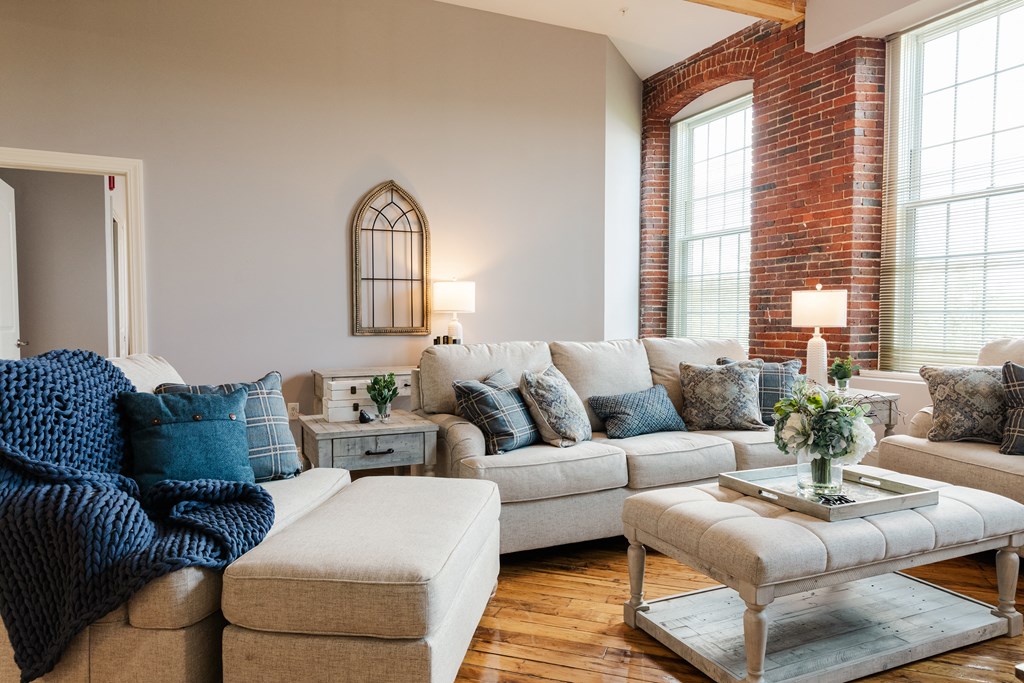 a living room filled with furniture and a large window
