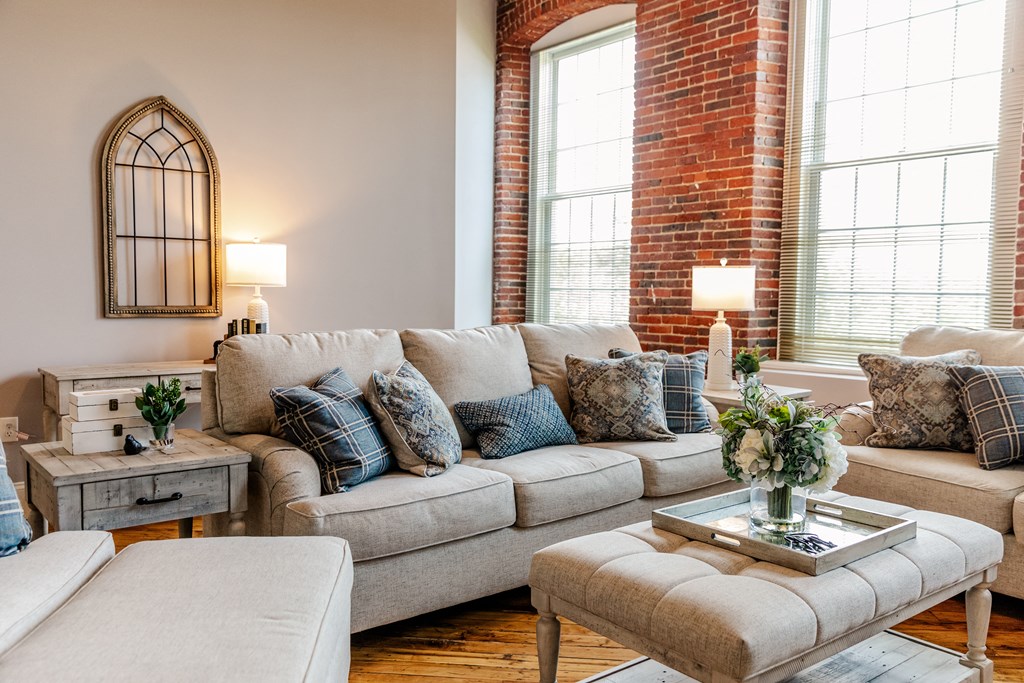 a living room filled with furniture and a large window