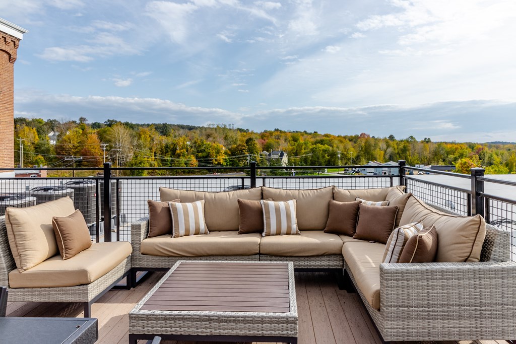 a living room with a couch and a table on a balcony