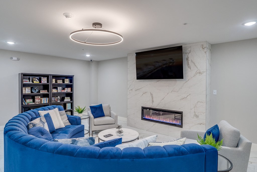 a living room with a blue couch and a fireplace