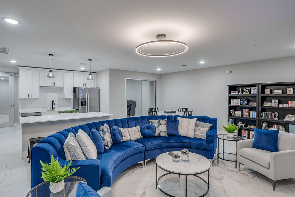 a living room with a blue couch and a kitchen