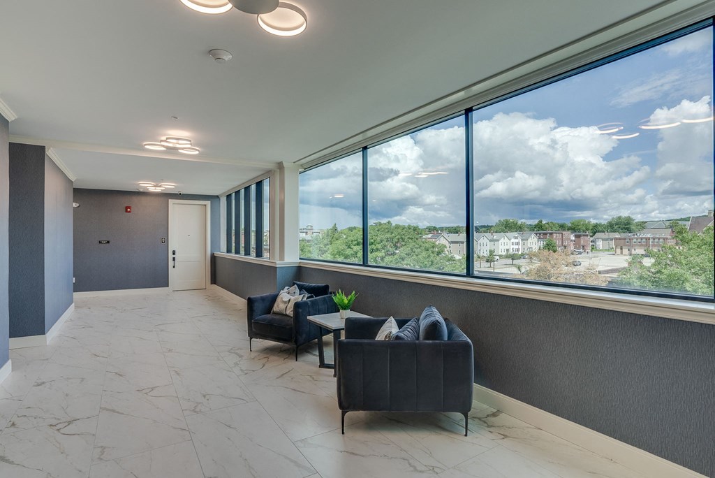 a lobby with couches and a window with a view of a city