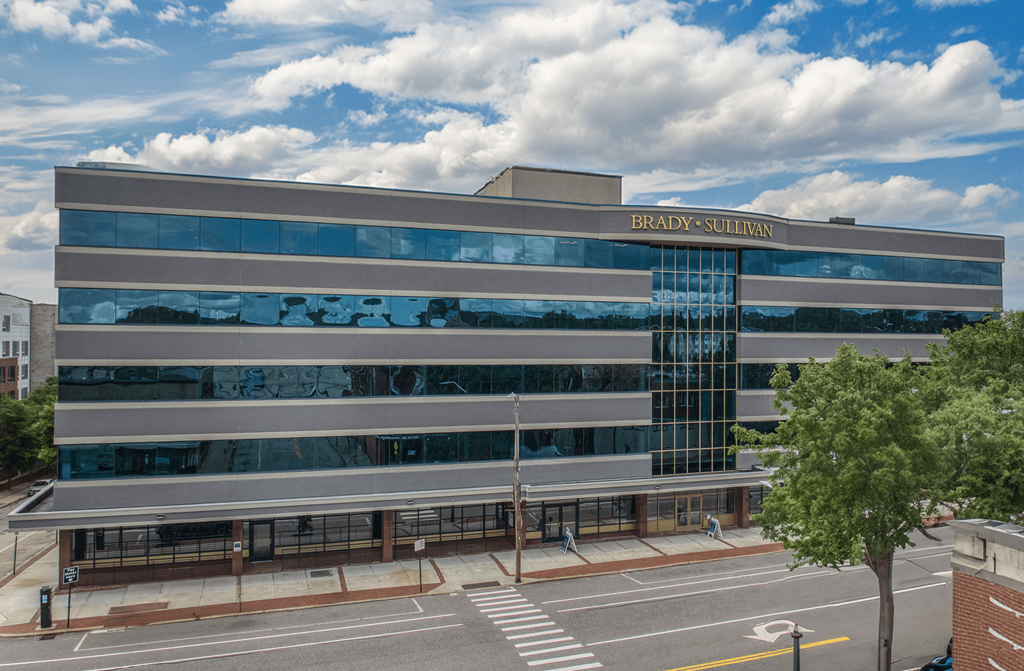 an office building with a glass facade with the words bulding guardian on it