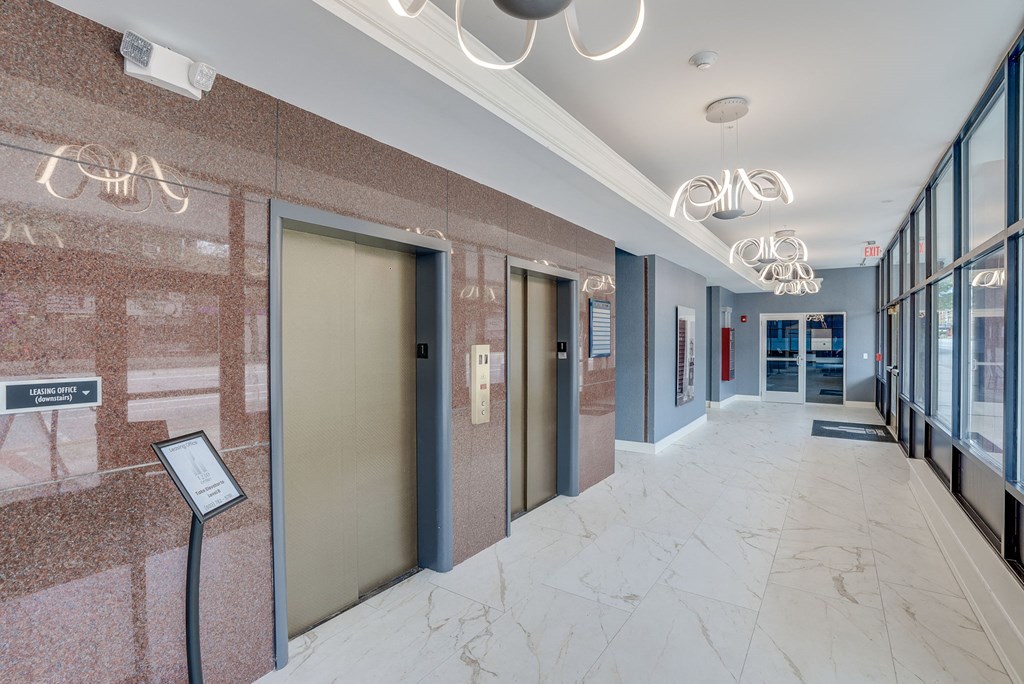 a hallway with elevators and doors in a building