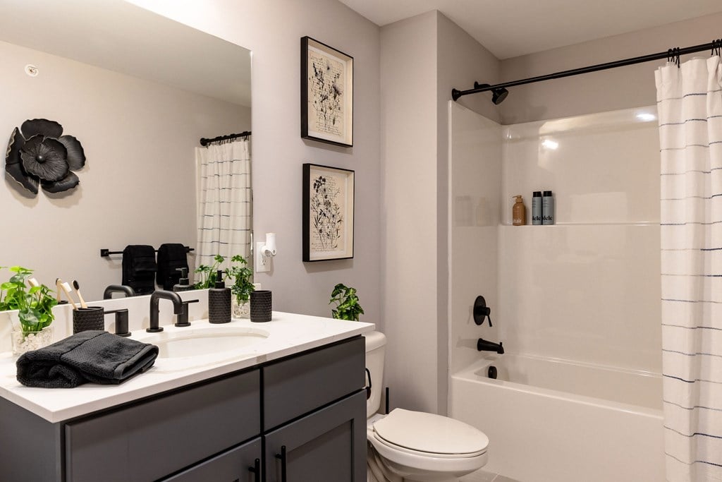 A bathroom with a white sink and a white toilet.