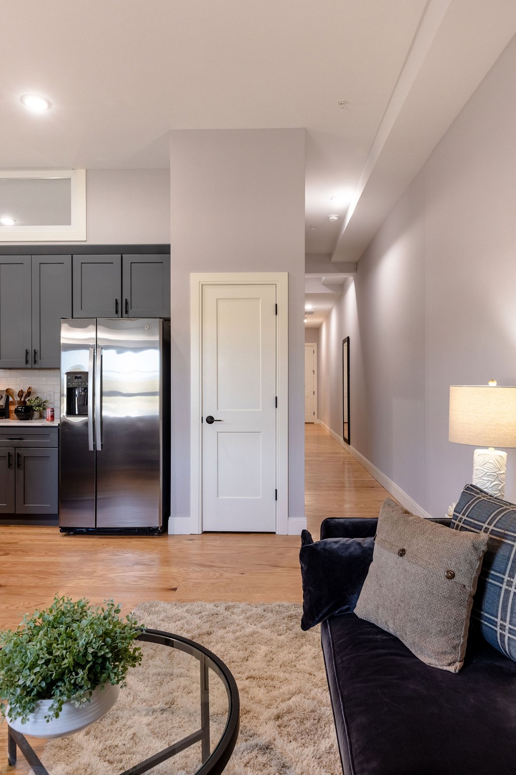 A modern kitchen with a refrigerator, cabinets, and a countertop.