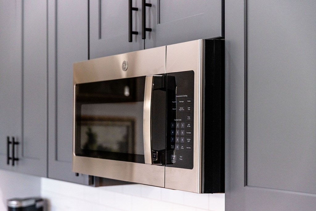 A stainless steel microwave oven with a digital display and control panel.