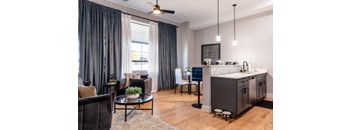 A modern kitchen with a dining area and a living room.