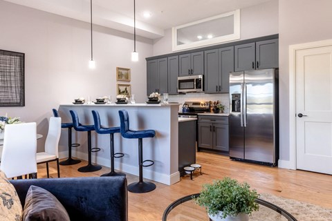 A kitchen with a bar area and a dining table.