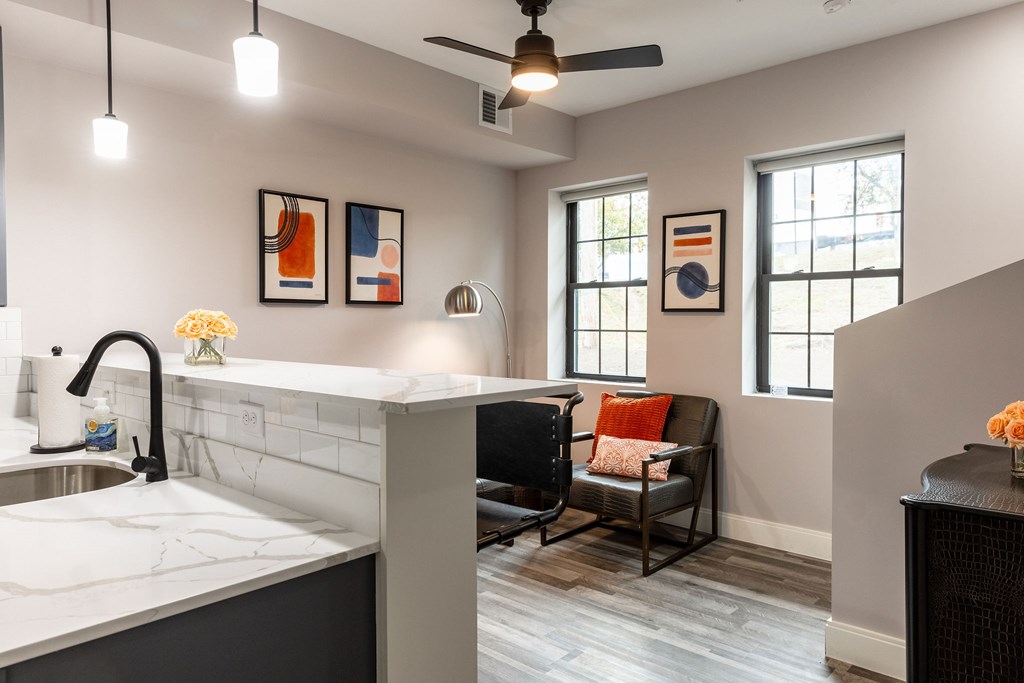 A kitchen with a marble countertop and a ceiling fan.
