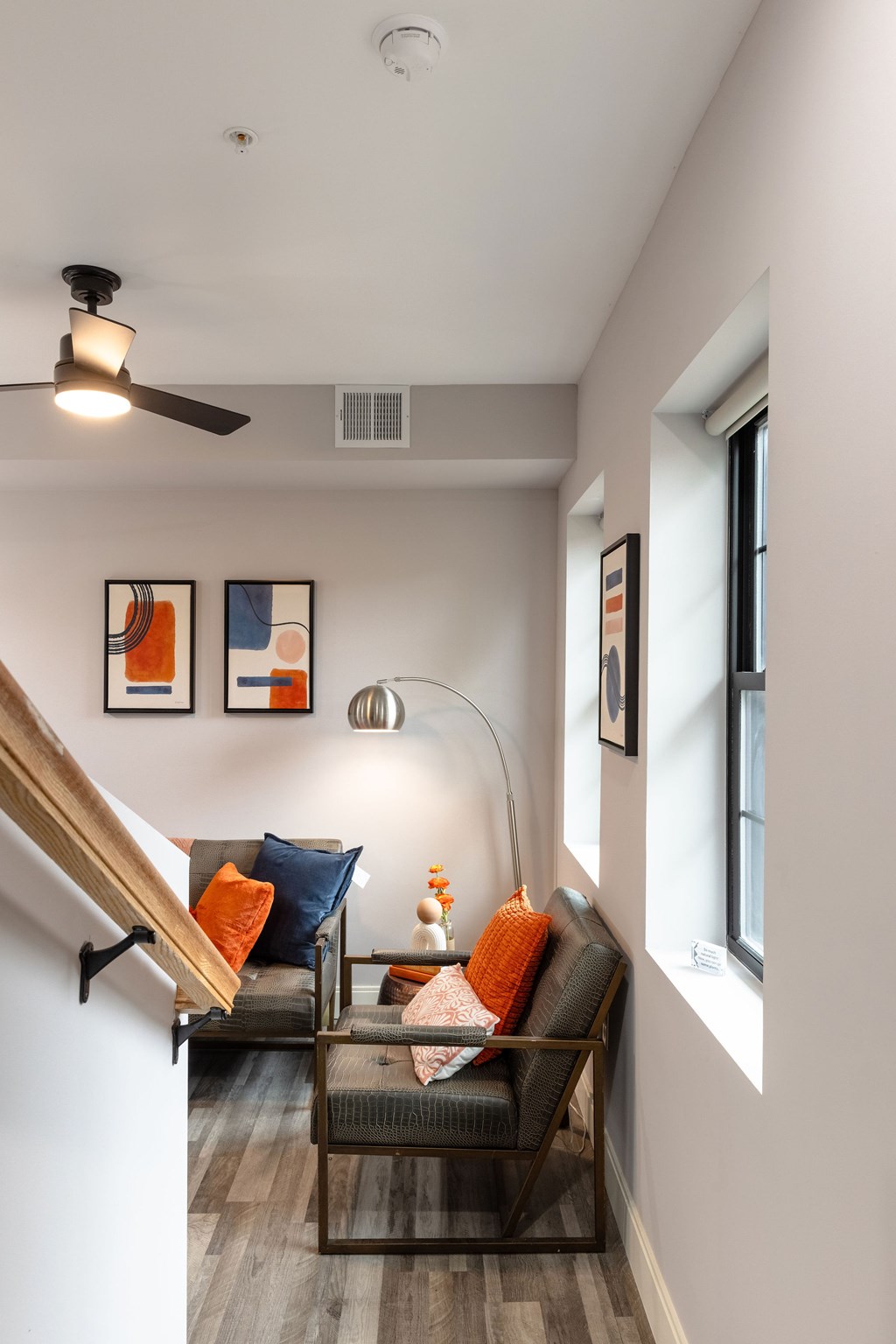 A living room with a couch and a ceiling fan.