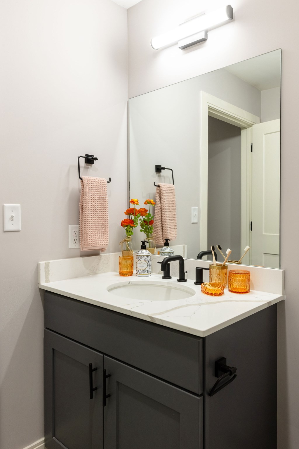A bathroom with a sink and a mirror.
