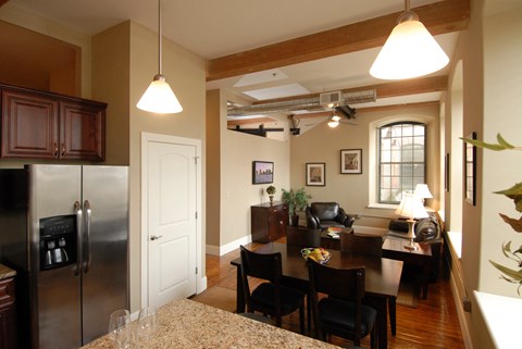 a kitchen and dining room with a table and a refrigerator