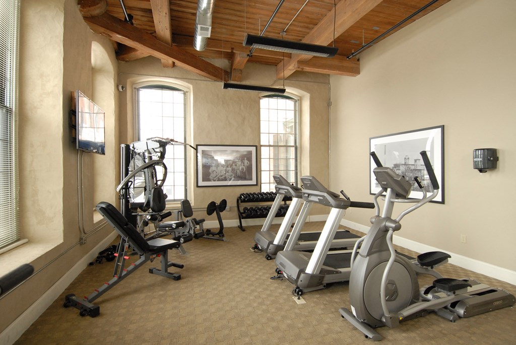 a gym with treadmills and other exercise equipment