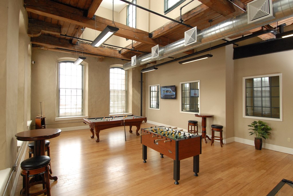 a game room with a pool table and foosball