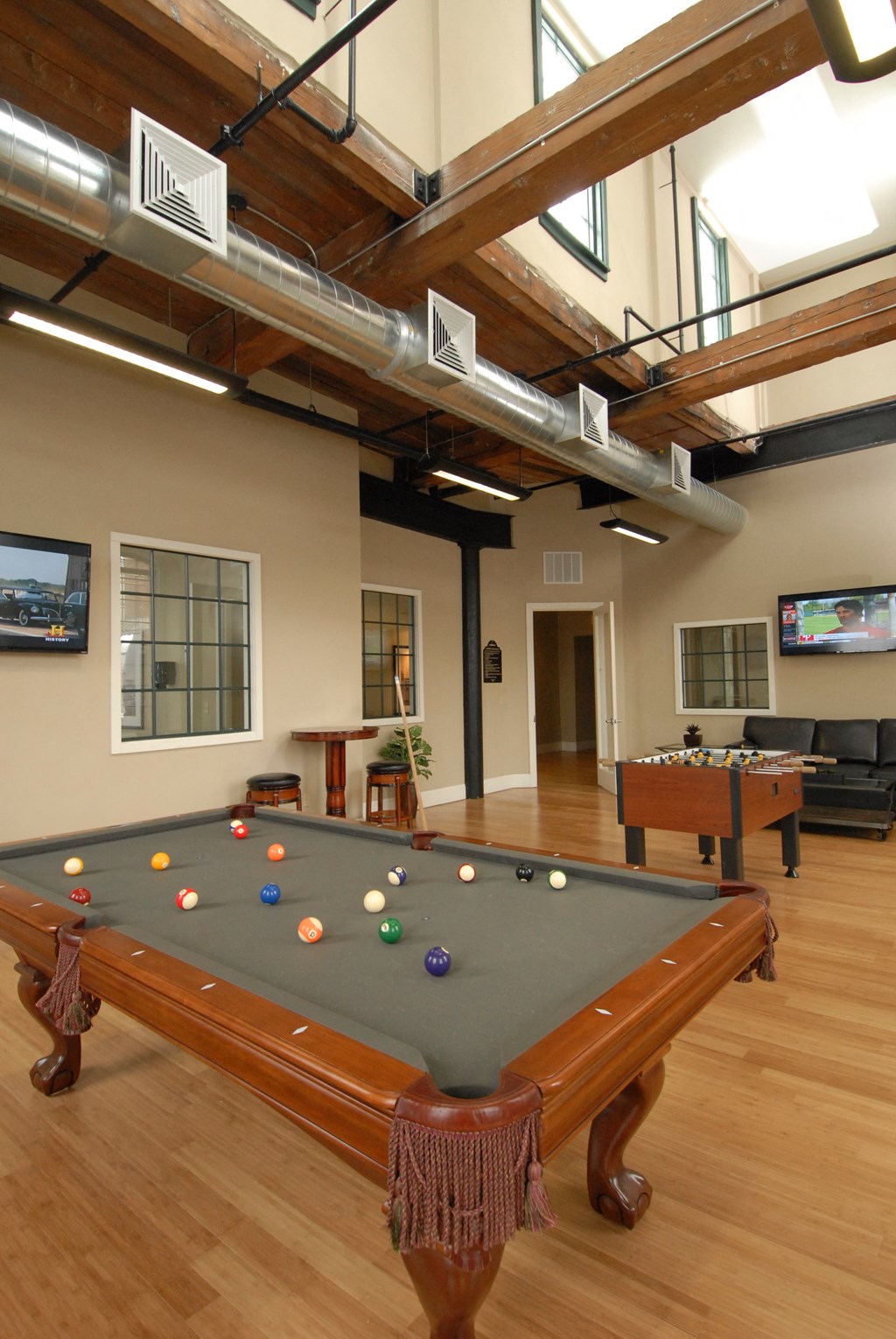 a game room with a pool table and billiards