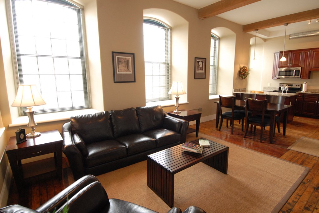 a living room with a leather couch and a coffee table