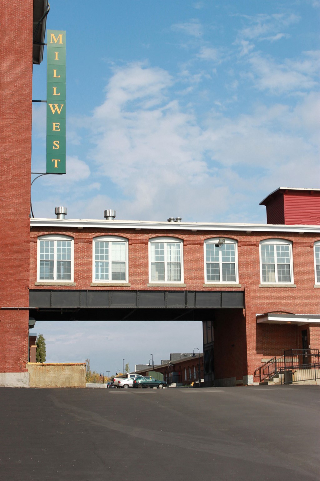 a brick building with a bridge over a street