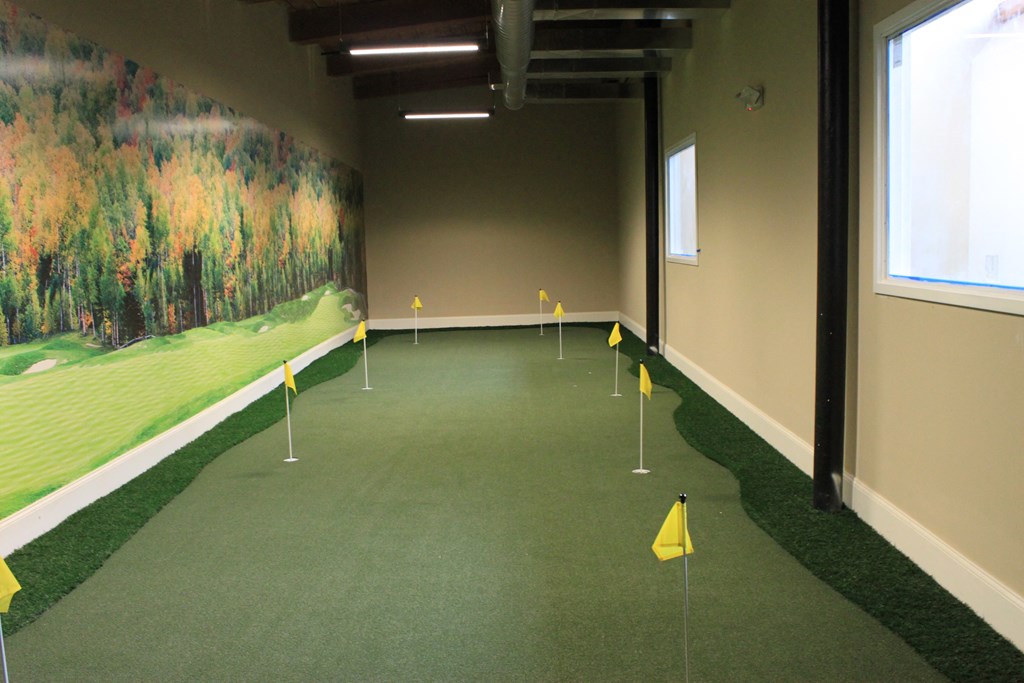 a golf room with yellow flags and a painting on the wall