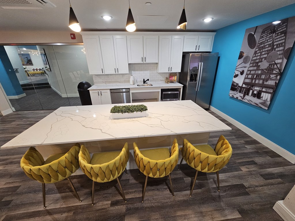 a kitchen and dining room with a white table and yellow chairs