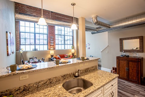 a kitchen with granite counter tops and a large window