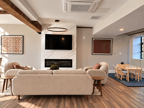 A living room with a fireplace and a television.