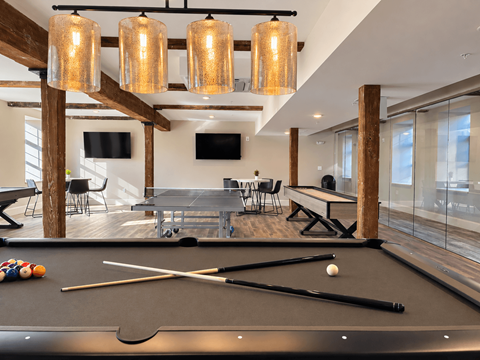 A pool table with a white ball and two cues on it.