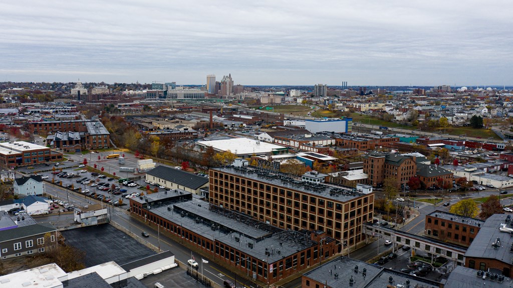 an aerial view of a city with a building and a parking lot