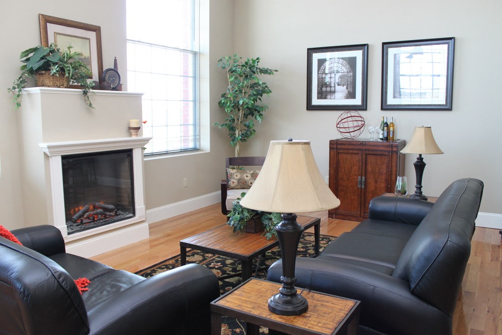 a living room with leather furniture and a fireplace