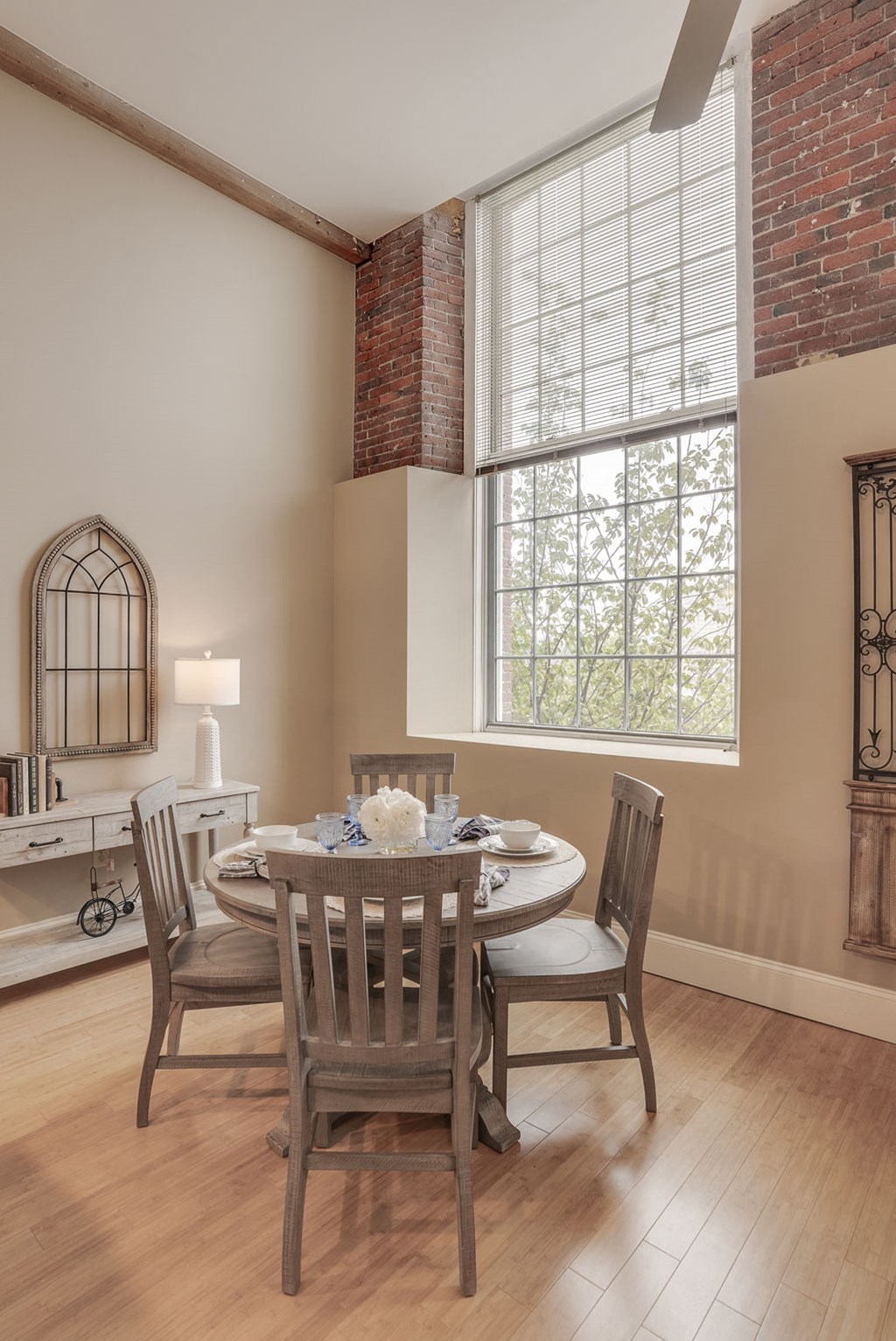 a dining room with a table and chairs and a large window