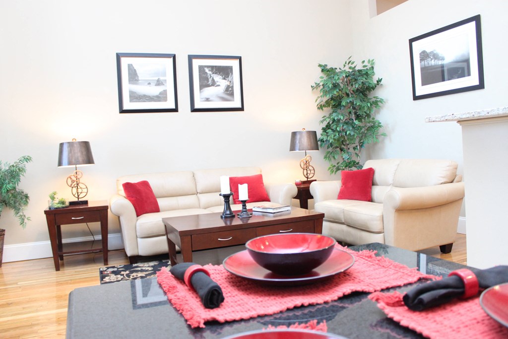 a living room with white couches and a table