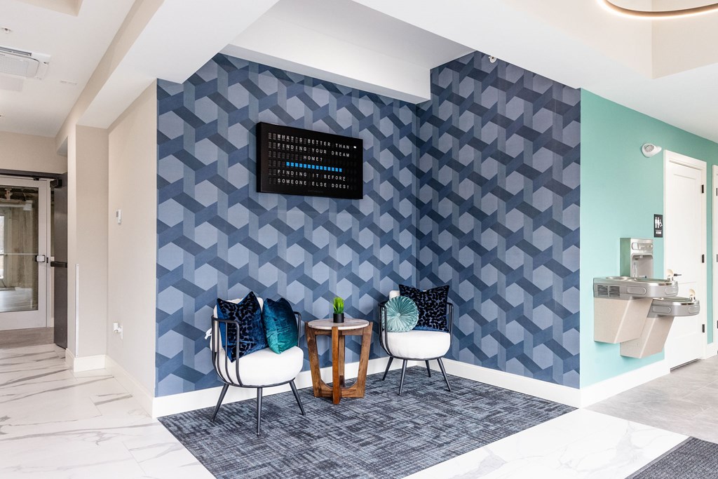 A wall with a pattern of blue hexagons with a black sign on it.