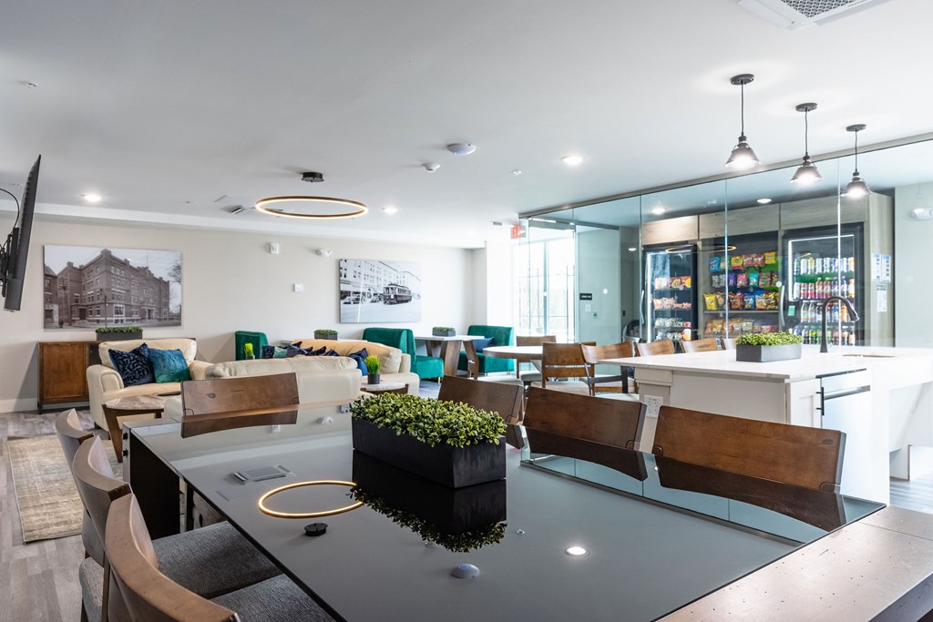 A modern dining area with a glass table and chairs.