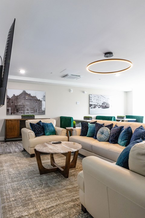 A living room with a white couch and a coffee table.