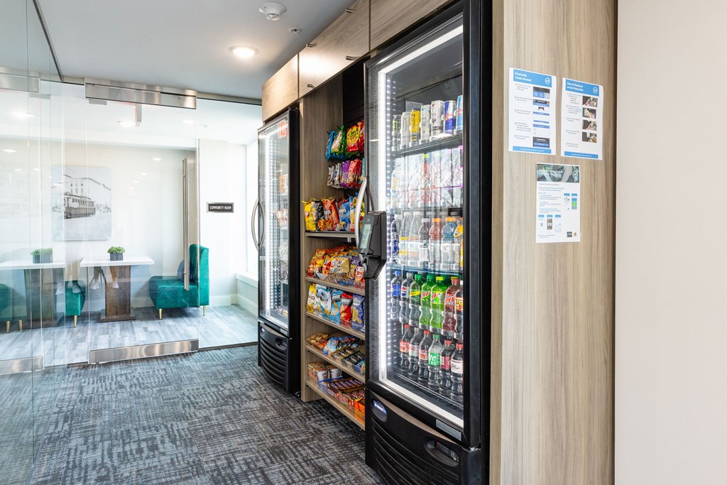 A vending machine with a variety of snacks and drinks inside a modern office space.