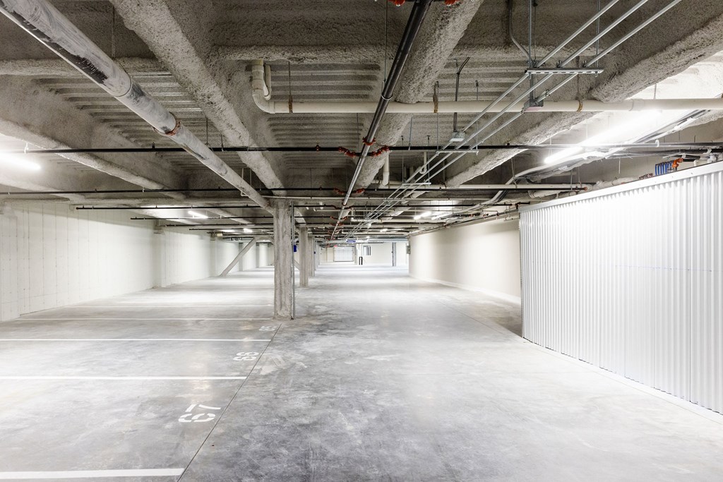 A large, empty parking garage with concrete floors and walls.