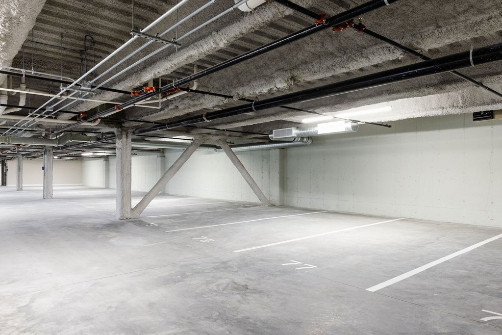 A large, empty parking garage with concrete floors and walls.