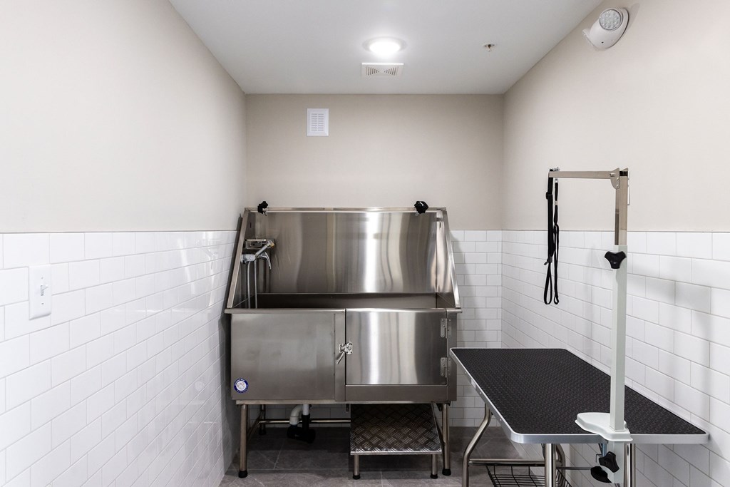 A stainless steel kitchen with a large pot on the stove.