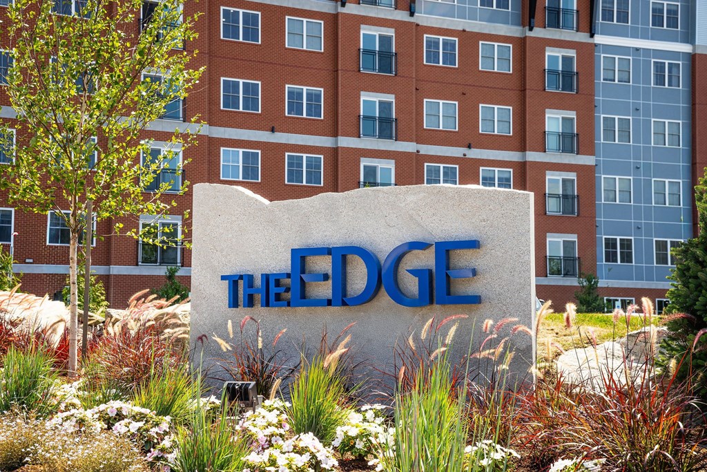 A sign that says "The Edge" in front of a building.