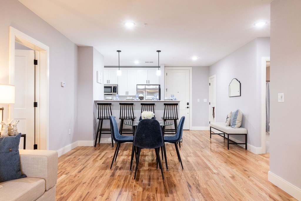 A dining room with a table set for six.