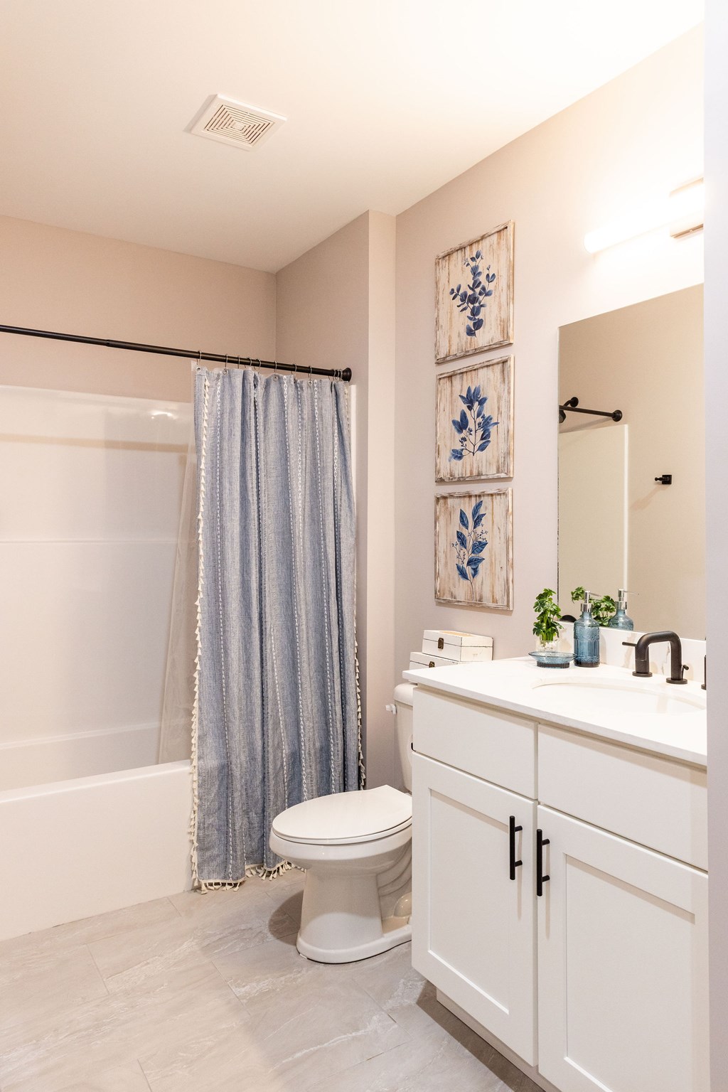 A bathroom with a toilet, sink, and shower.