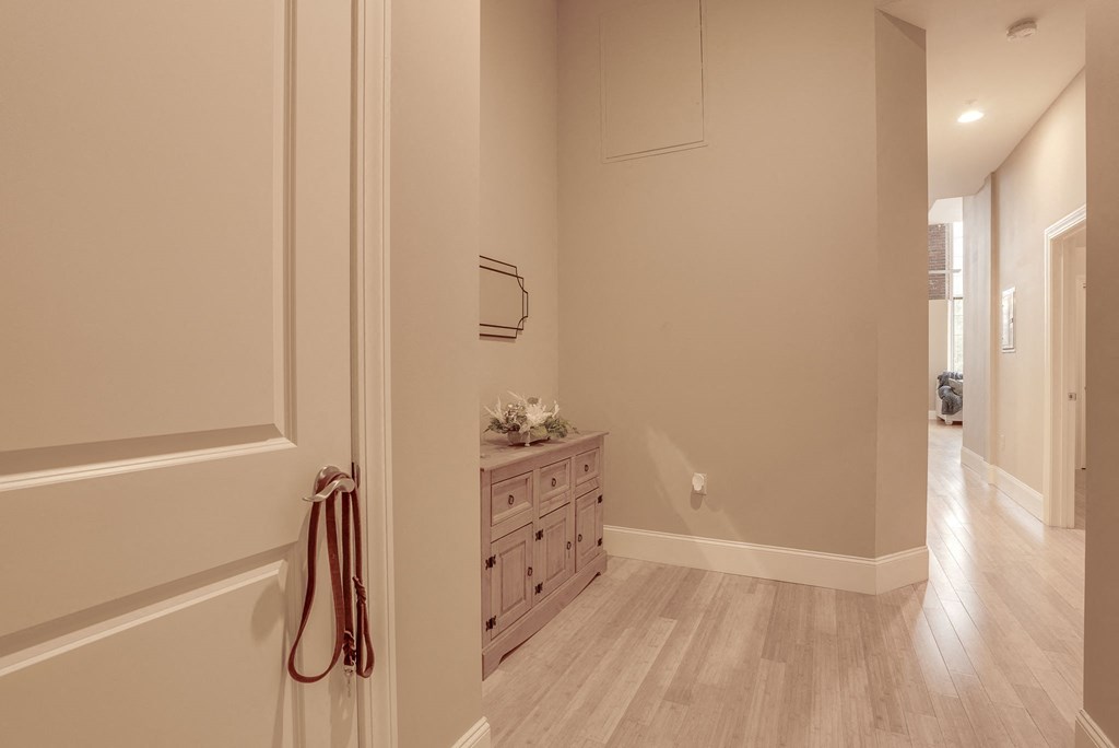 a hallway with a dresser and a mirror in a house