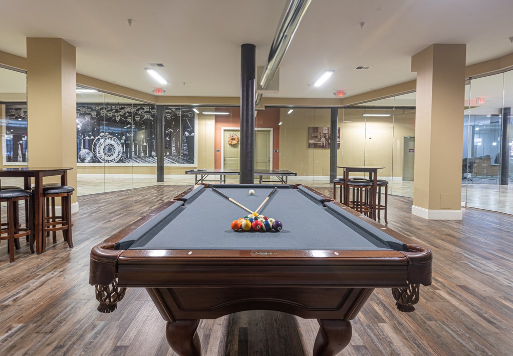 a billiards table in a clubhouse with a pool