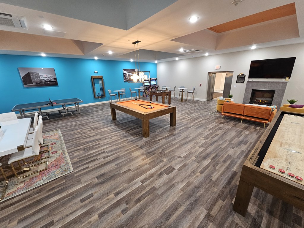 a game room with a pool table and a television