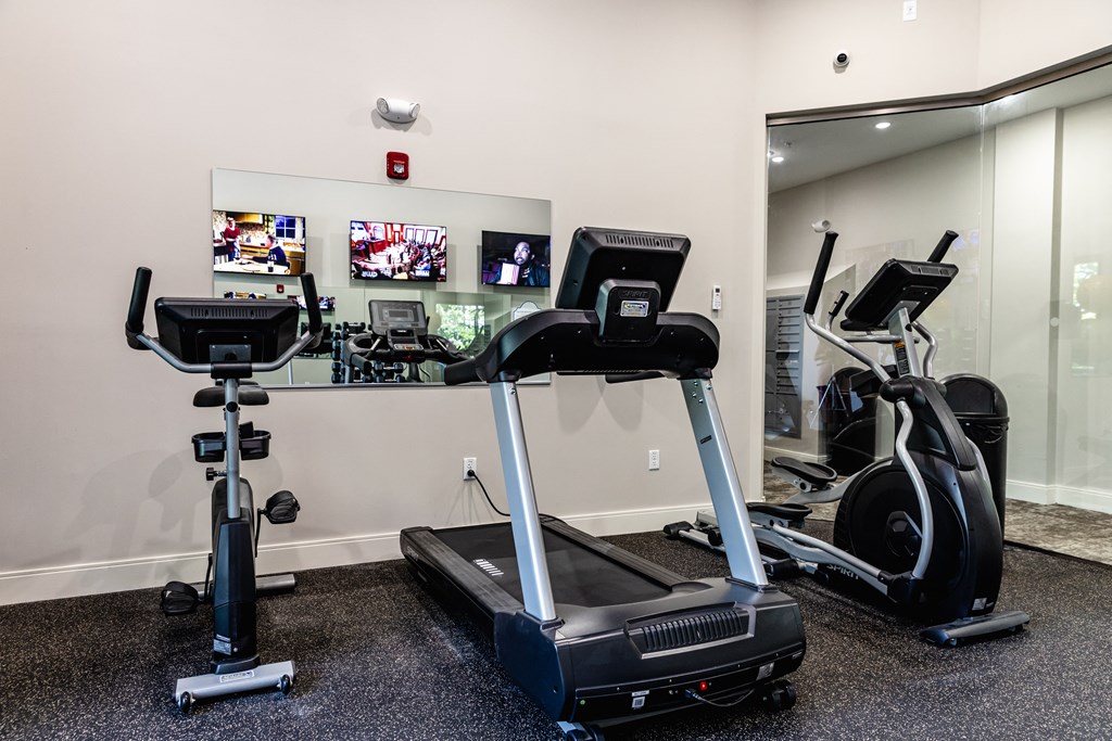 a gym with treadmills and other exercise equipment