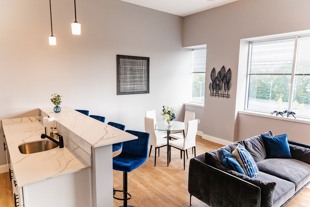 a living room with a kitchen and dining area