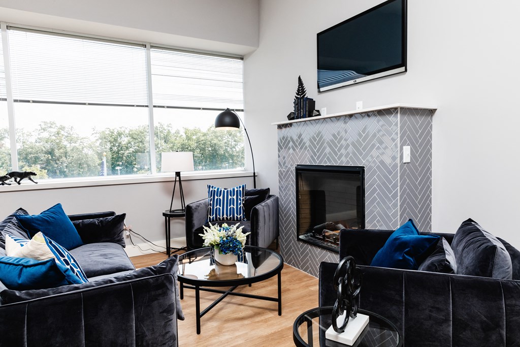 a living room with a fireplace and a flat screen tv